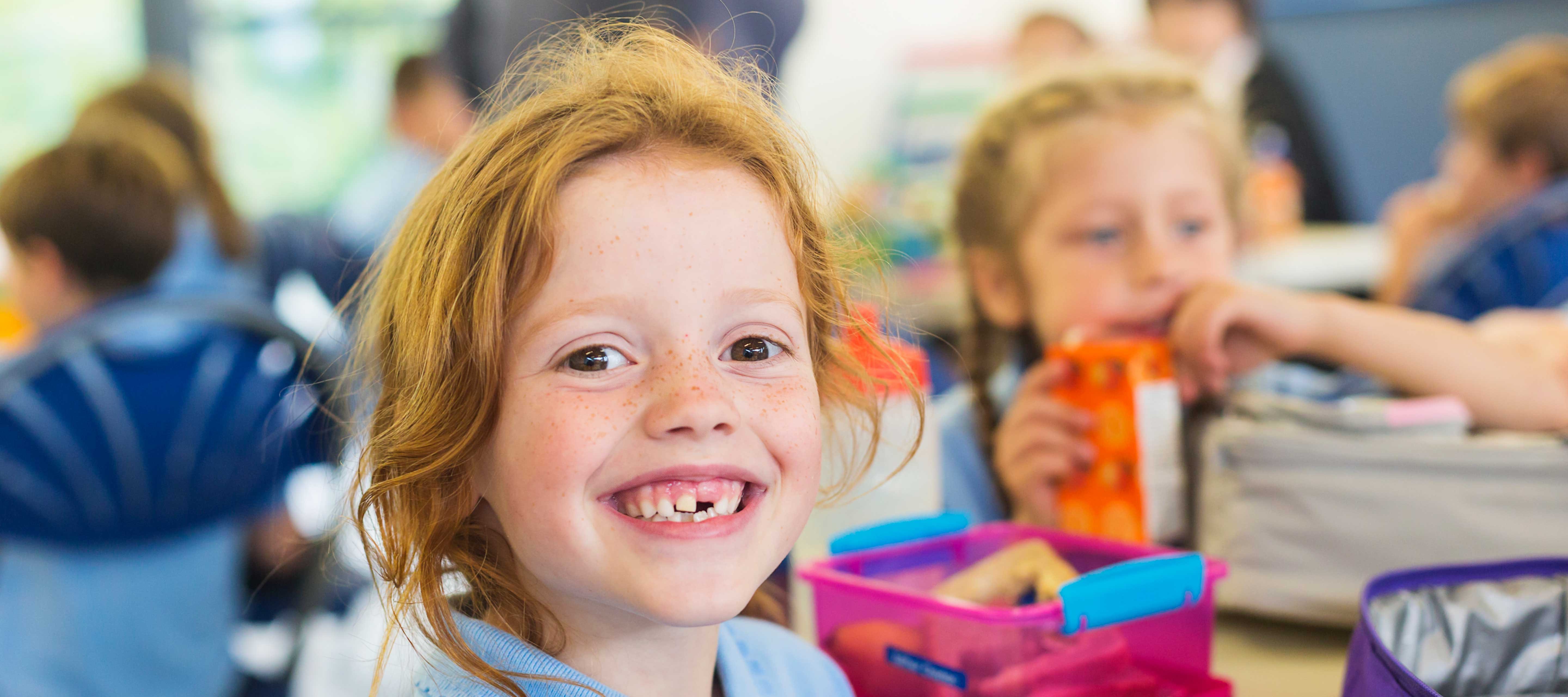 Heroic-Fundraising-Blog-Featured-Image-Girl-Smiling-Eating-Food-Bank