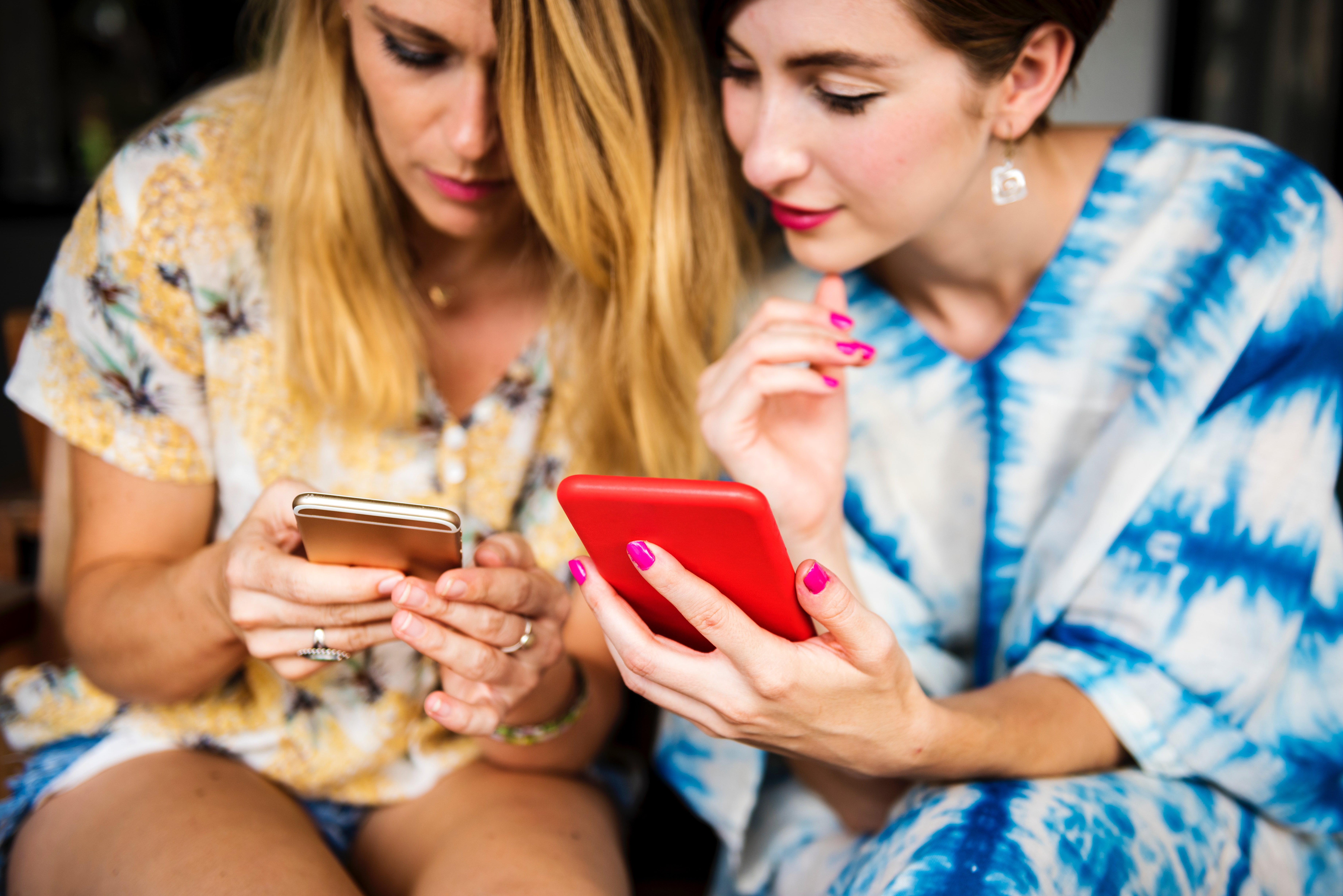 young adult women looking at phones